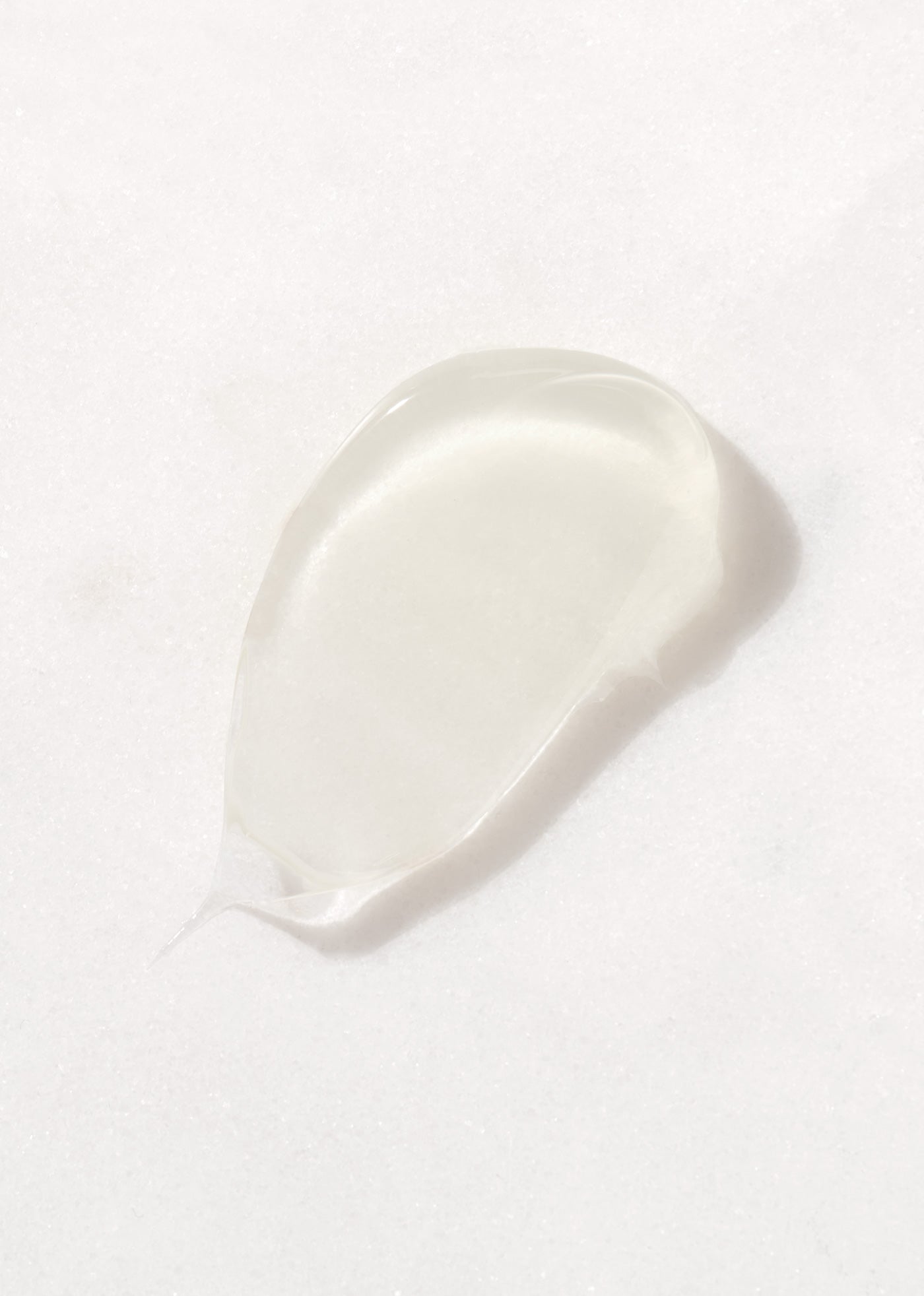 Smear of translucent After Show Treatment Cleanser for Sensitive Skin on white background.
